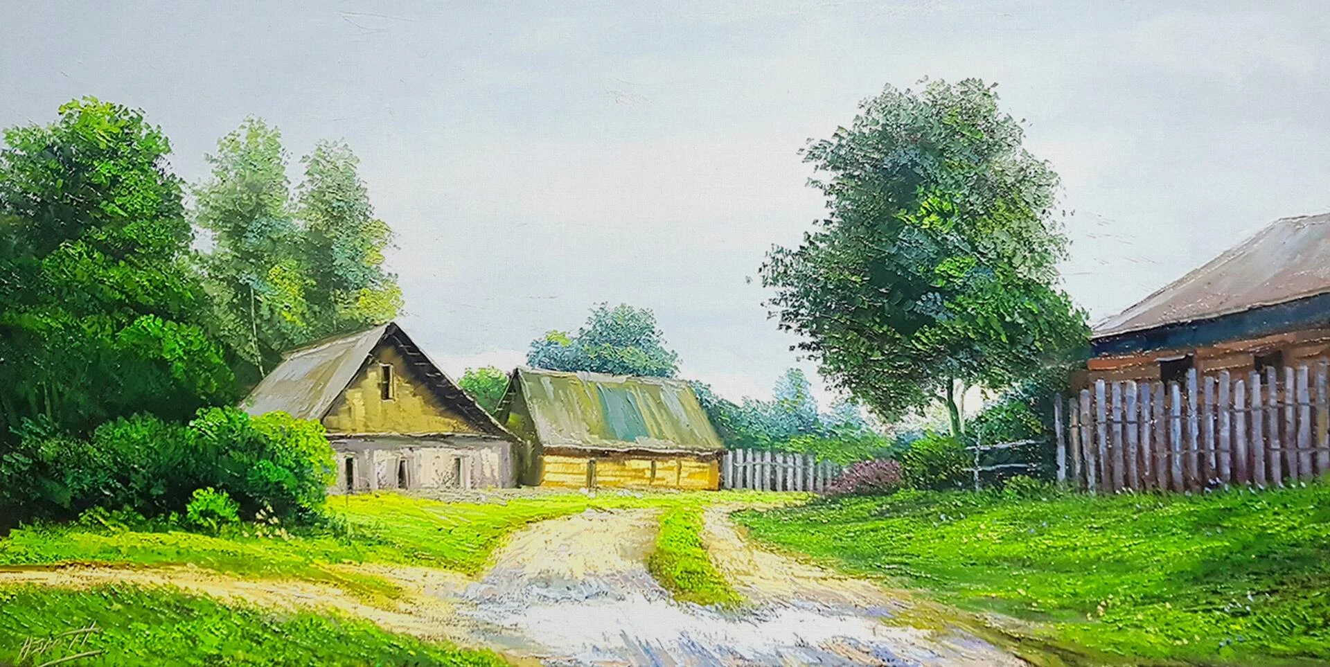 Casas rurales junto a un camino entre árboles verdes